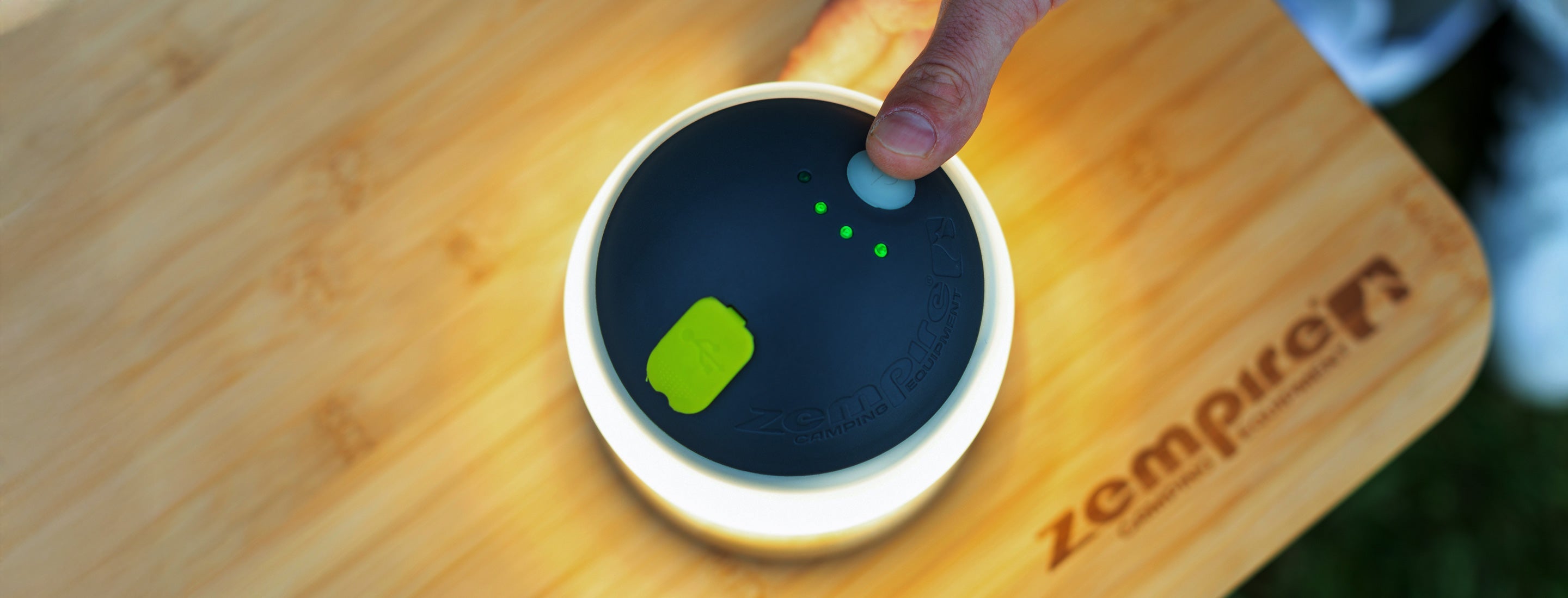 Zempire megadome camp light on a wooden surface, featuring the brand 'Zempire'.